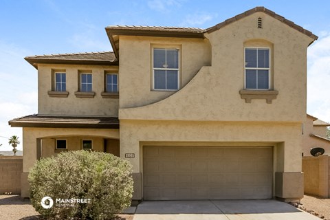 a house with a garage door in front of it