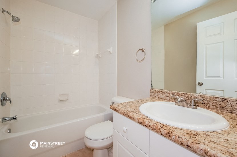 a bathroom with a sink and a tub and a toilet