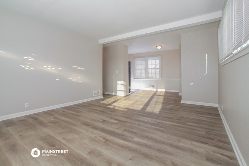 the living room and dining room of a new home with wood flooring