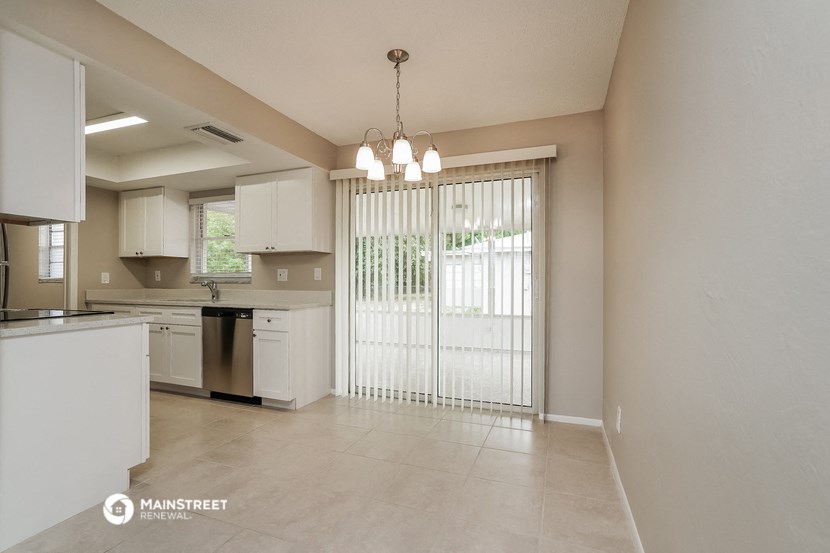 a kitchen with a large sliding glass door to the patio