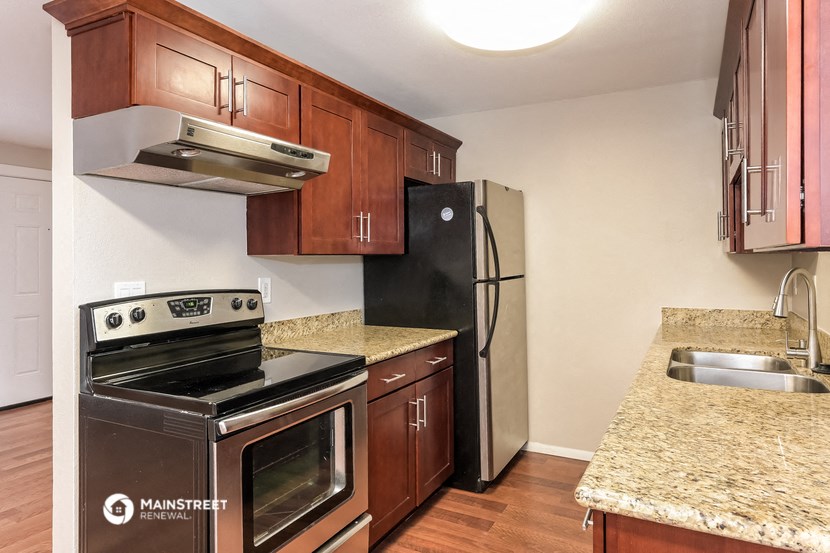 a kitchen with stainless steel appliances and granite counter tops