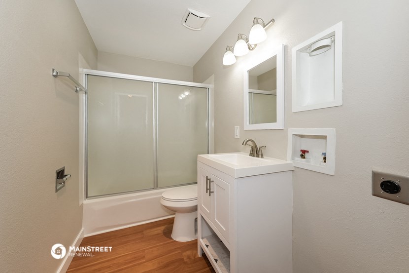 a bathroom with a toilet sink and a shower