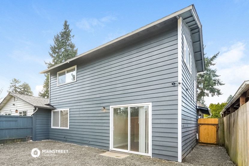 the exterior of a house with blue siding and a glass door