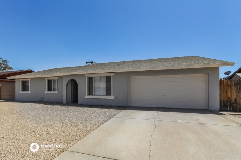 the front of a house with a driveway and a garage door