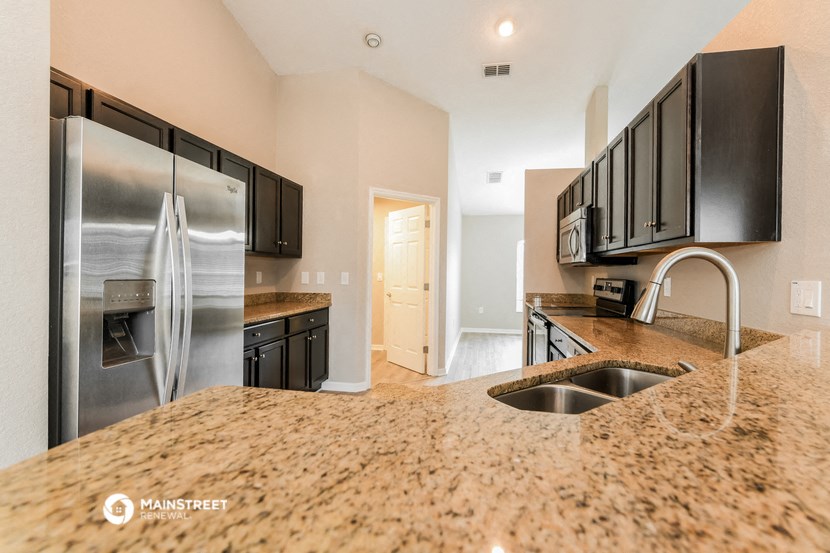 a kitchen with granite counter tops and stainless steel appliances