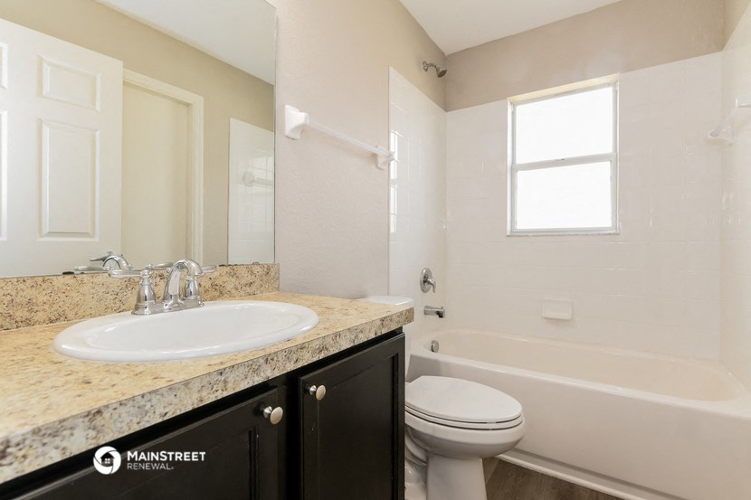 a bathroom with a sink and a toilet and a bath tub