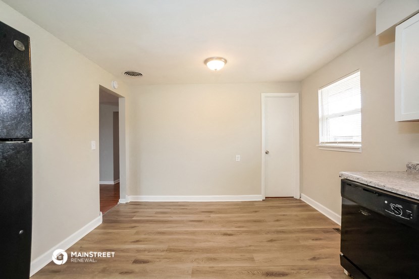 the interior of a renovated kitchen with white walls and wood flooring