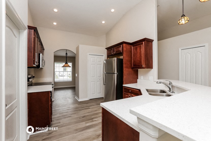 the kitchen is open to the living room and dining room