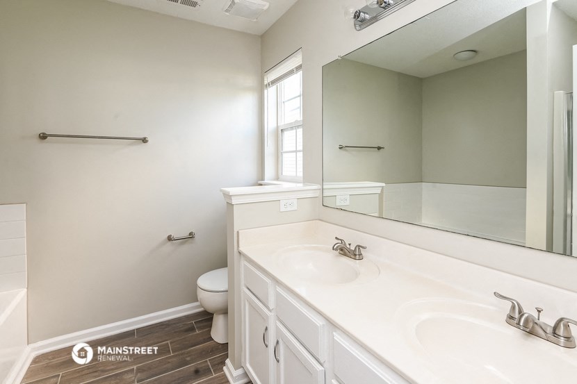 a bathroom with a sink and a mirror and a toilet