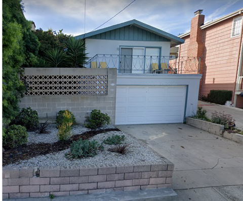 a white garage door in front of a house