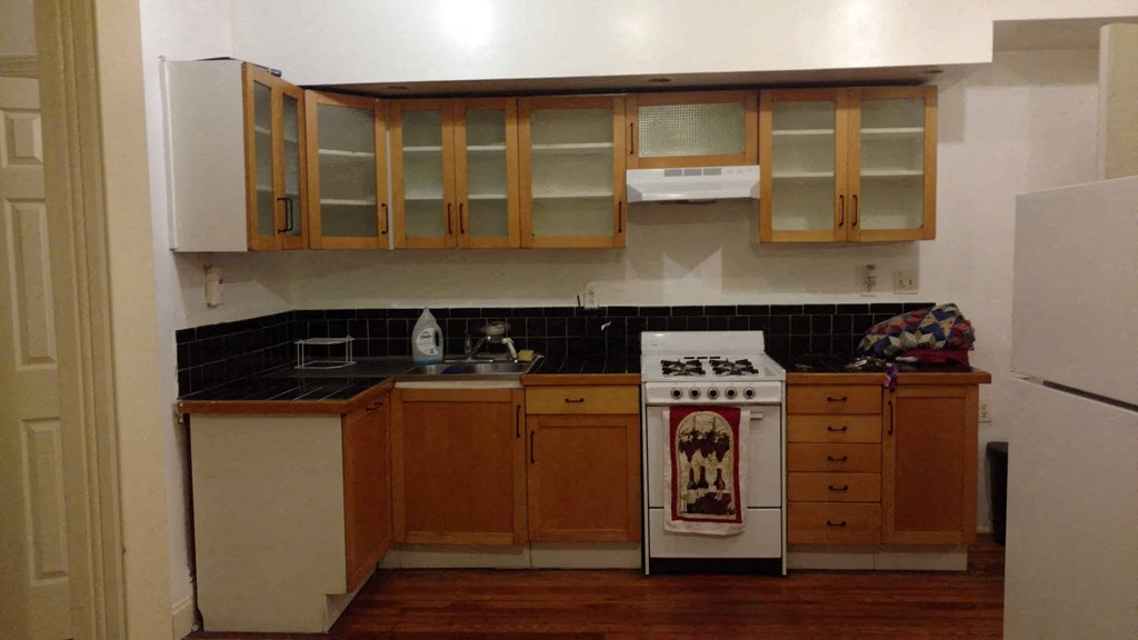 a kitchen with wooden cabinets and white appliances