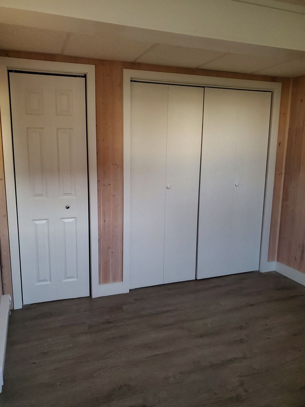 the closet in the living room with the doors closed