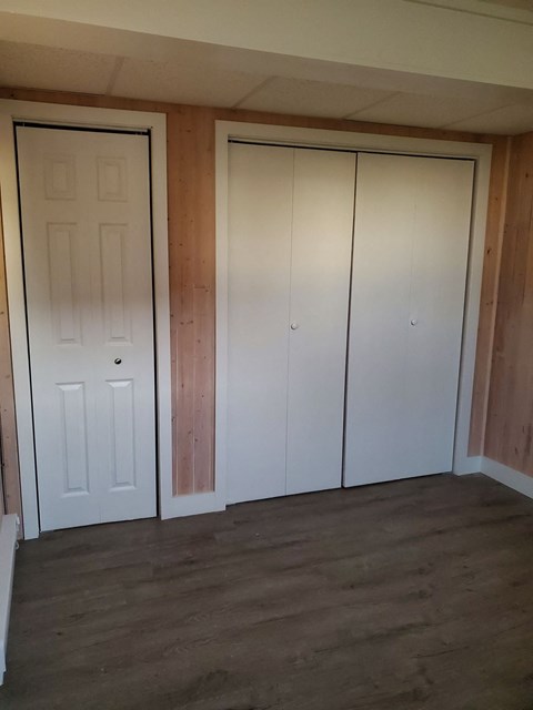 the closet in the living room with the doors closed