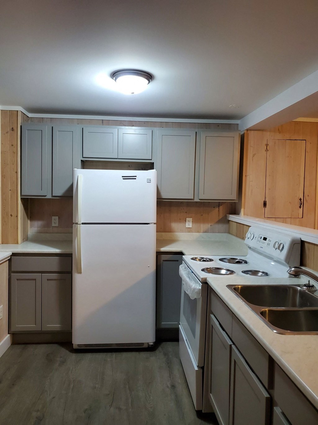 a kitchen with white appliances and wooden cabinets