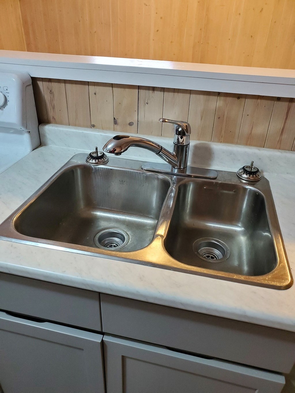 a stainless steel sink with a faucet in a kitchen