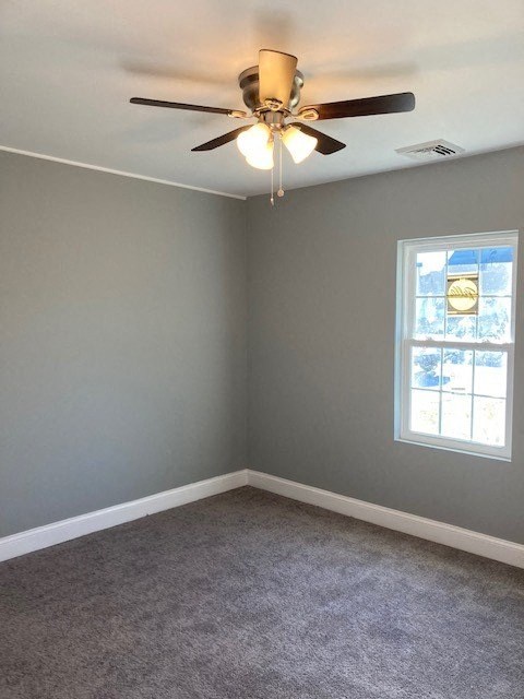 A room with a ceiling fan and a window.