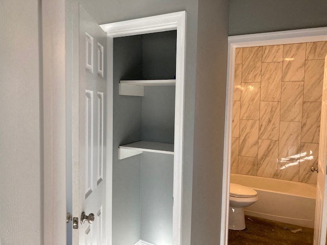 A white door is open to a bathroom.