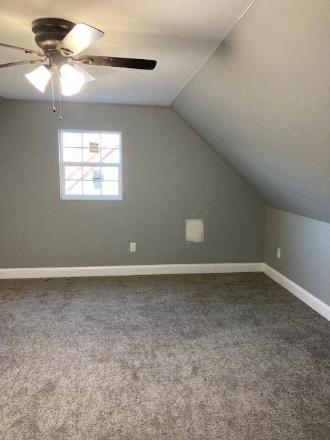 A room with a ceiling fan and a window.