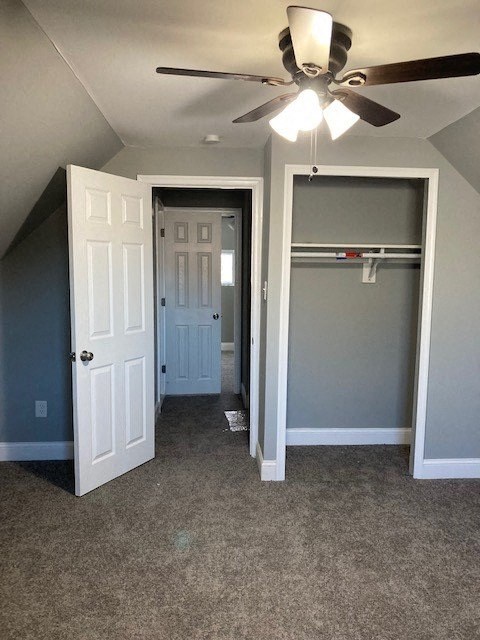 A room with a ceiling fan and two doors.