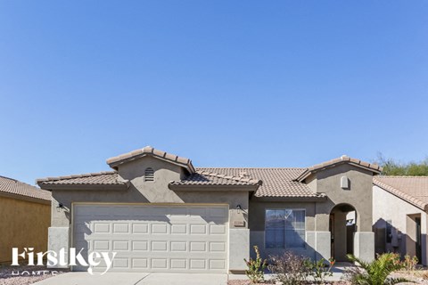 A house with a garage door and a sign that says "Firstkey" on it.