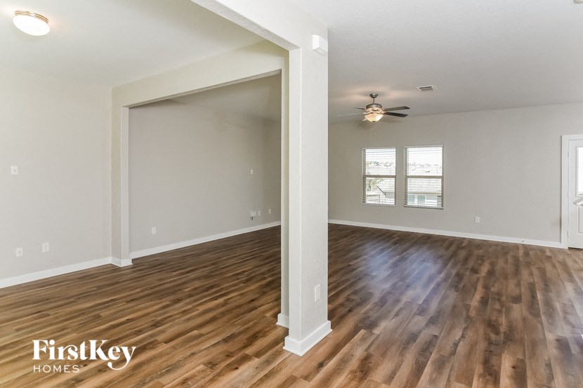 A room with wooden floors and a ceiling fan.