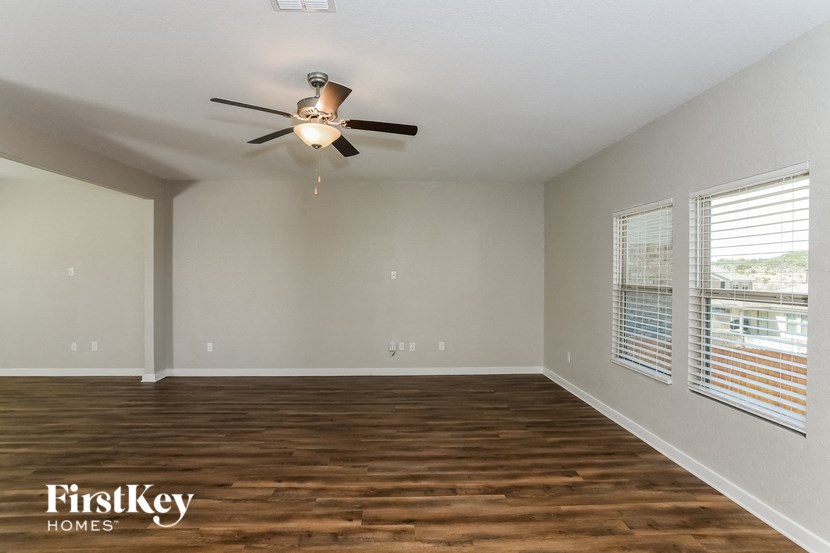 A room with wooden floors and a ceiling fan.