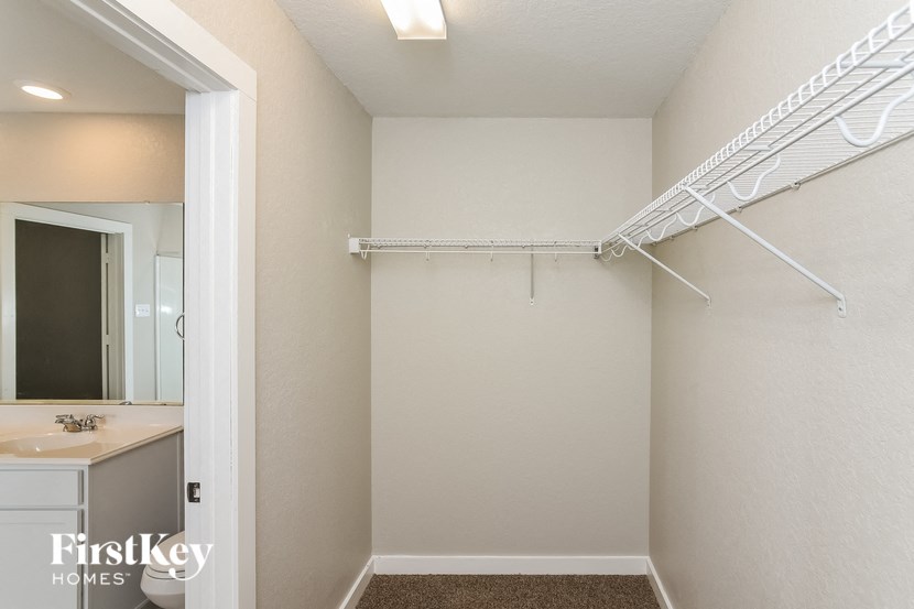 A white closet with a FirstKey Homes logo.