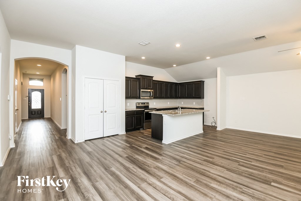 the kitchen is open to the living room and dining room