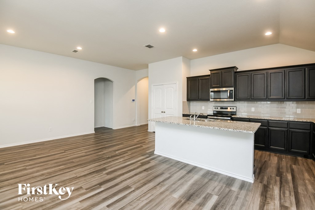 the kitchen is open to the living room and dining room