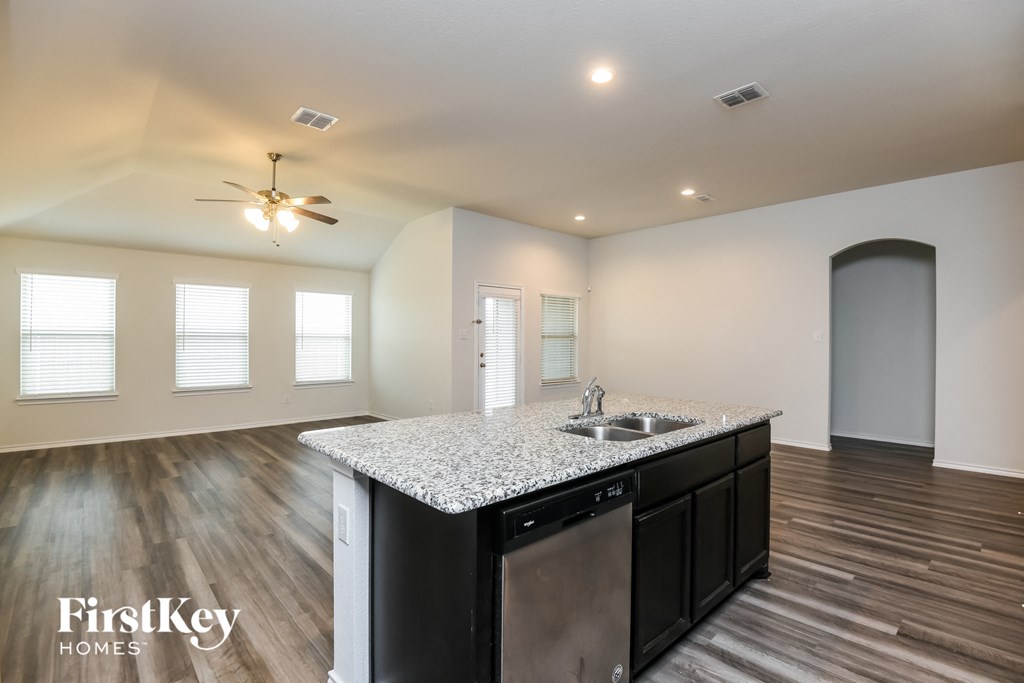 a kitchen with a granite counter top and a sink