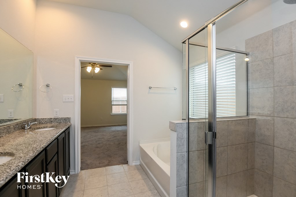 a bathroom with a shower and a sink and a bath tub