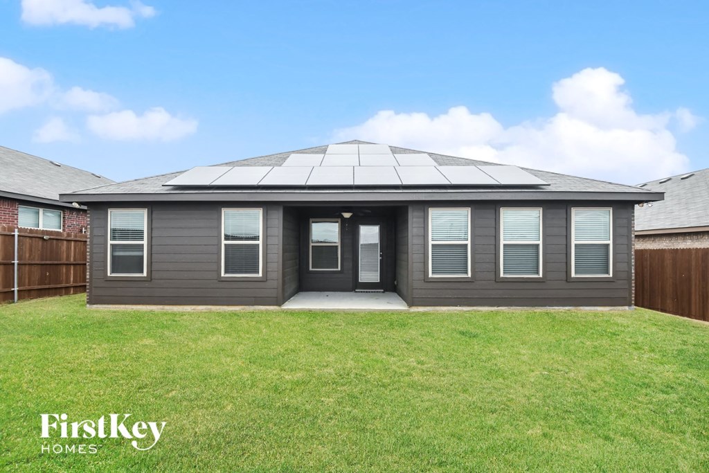 a home with a porch and a grass yard