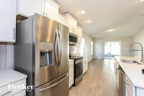 a kitchen with stainless steel appliances and white cabinets