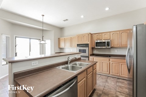 a large kitchen with wooden cabinets and stainless steel appliances