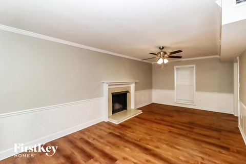 a living room with wood flooring and a fireplace