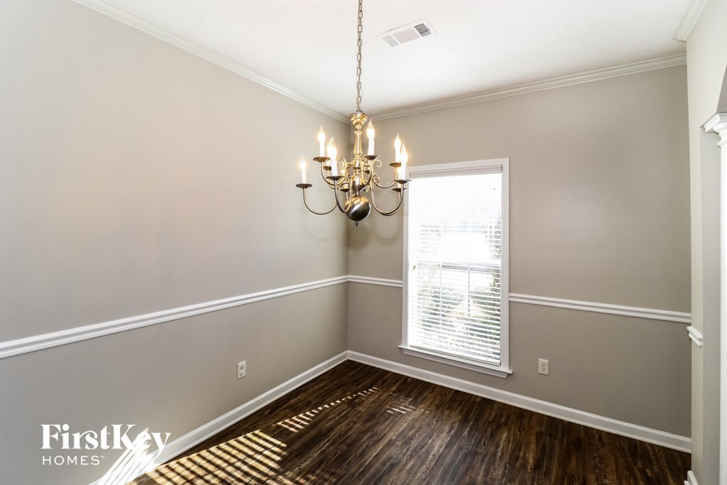 a dining room with a chandelier and a window