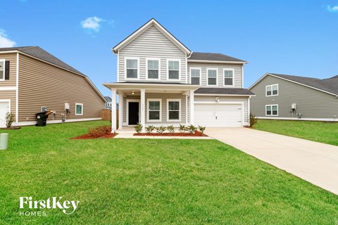 A large house with a driveway in front of it.