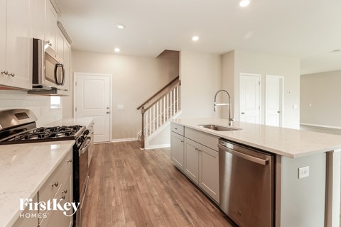 A kitchen with a stove top oven and a dishwasher.