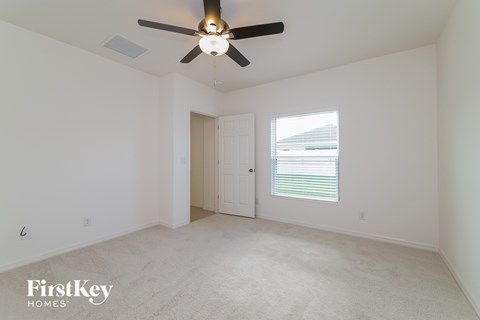 a living room with a ceiling fan and a window