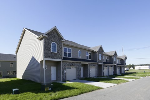 A row of houses with a clear blue sky above them.