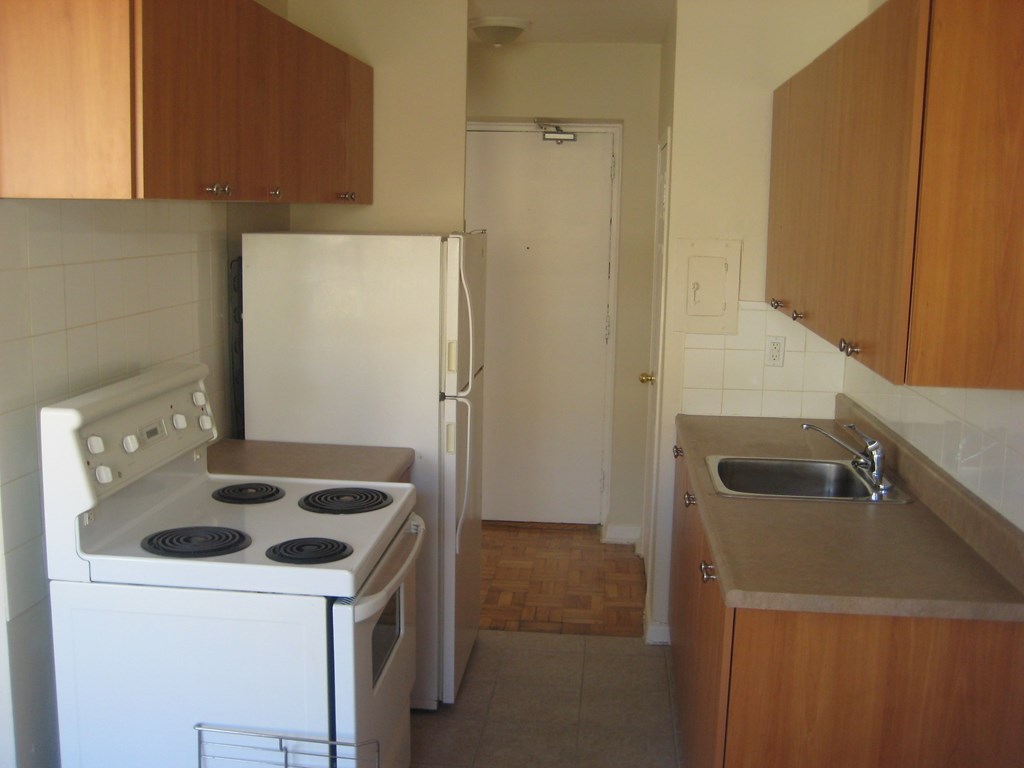 a kitchen with a stove and a sink and a refrigerator