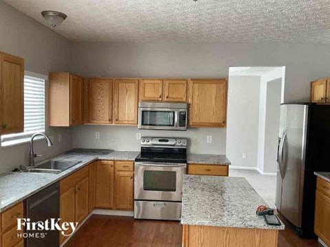 A kitchen with wooden cabinets and stainless steel appliances.
