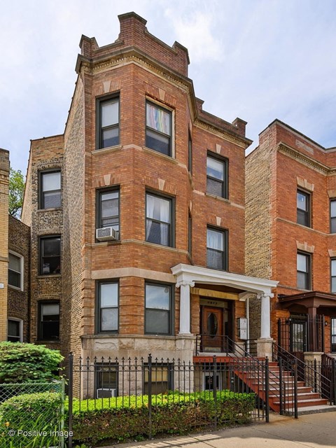 a large brick building with a porch and