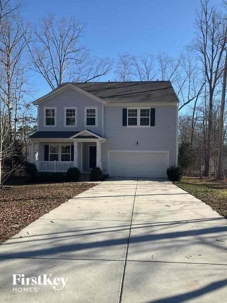 A two-story house with a garage is for sale.