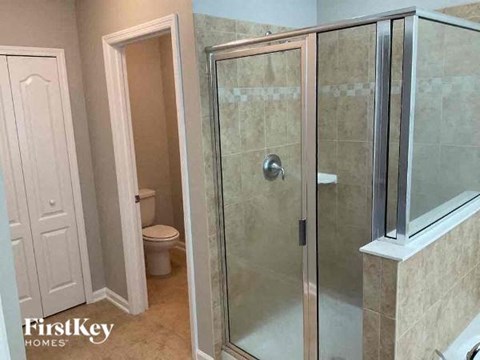 a bathroom with a shower and a toilet in it