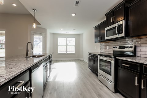 a kitchen with stainless steel appliances and marble counter tops