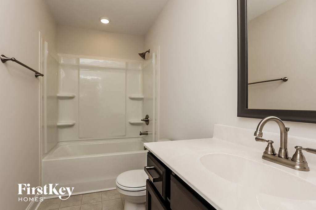 a bathroom with a sink and a shower and a toilet