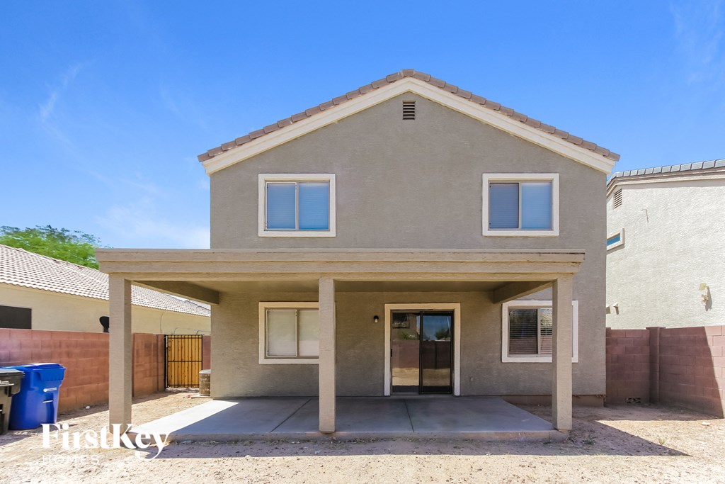 a house with a covered porch and a trash can in front of it
