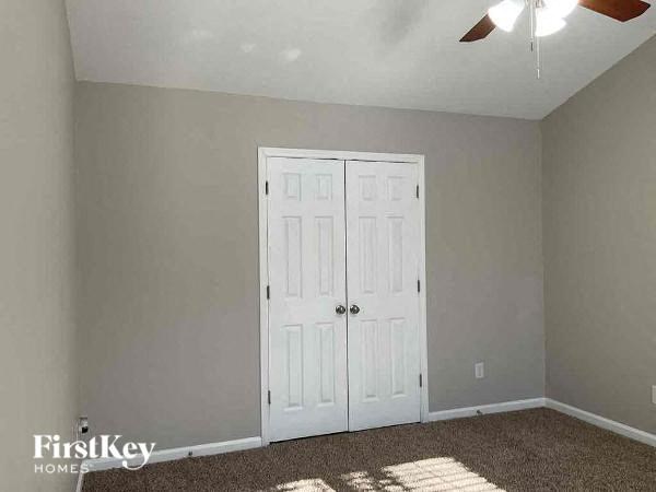 a room with two white doors and a ceiling fan