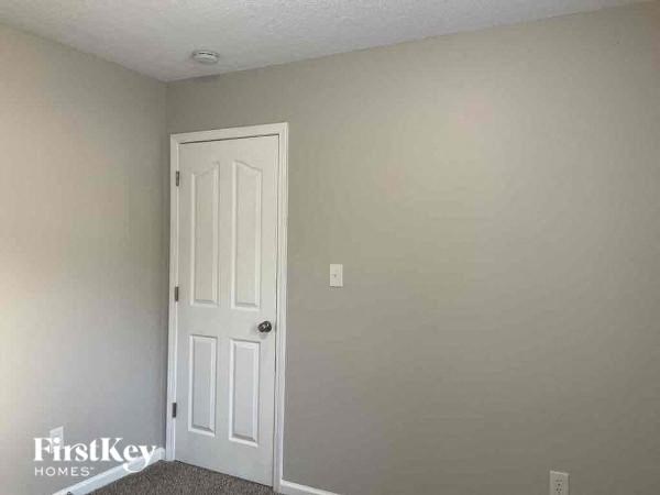 a white door in a room with a white wall